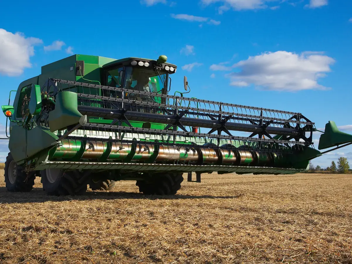 Harvester working an Australian crop at sunset