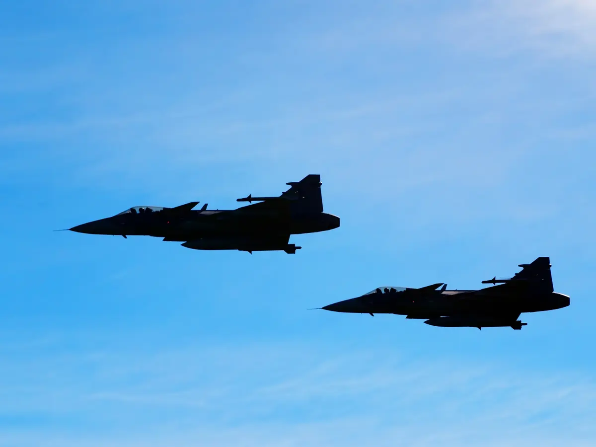 Defence aircraft on runway at sunrise