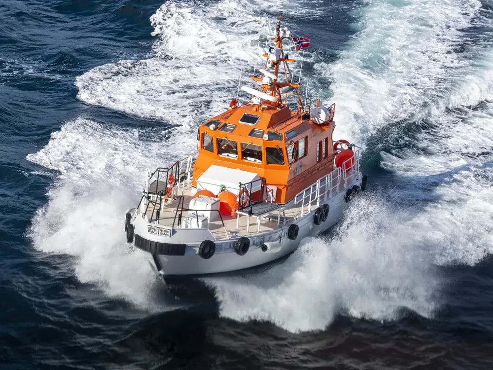 Workboat running through heavy surf