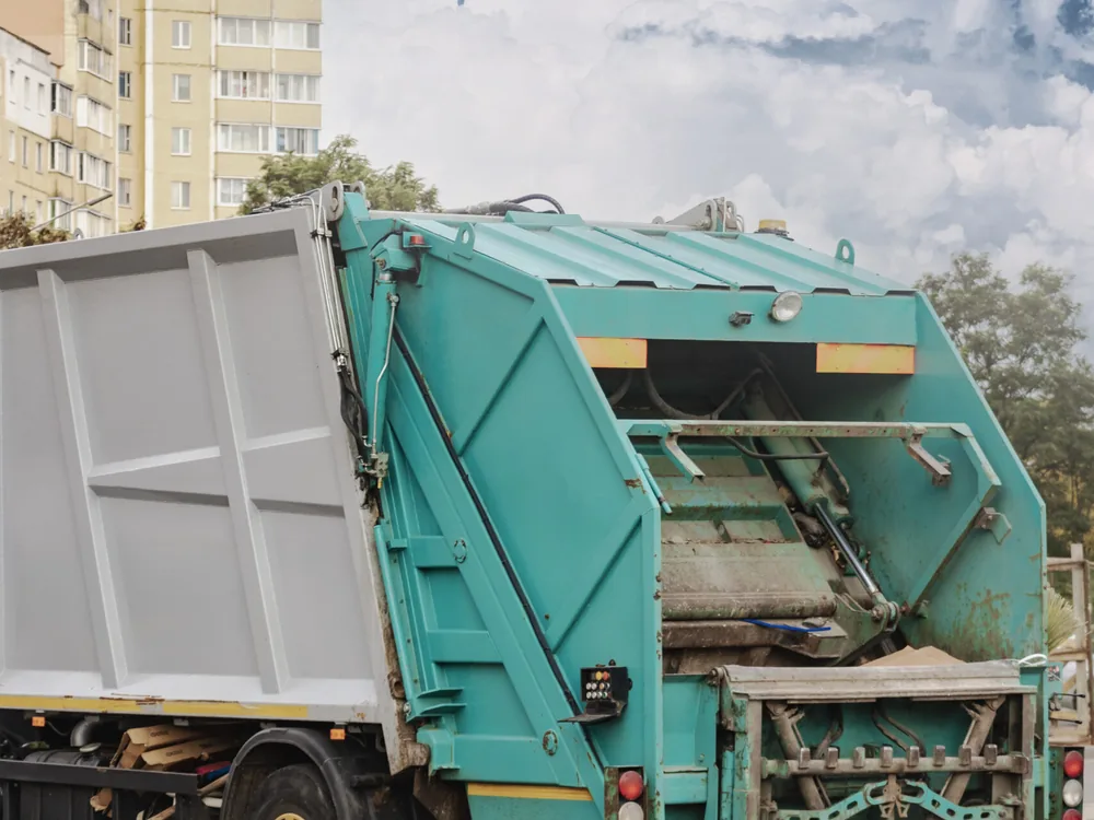 Garbage truck loading a bin on a residential street